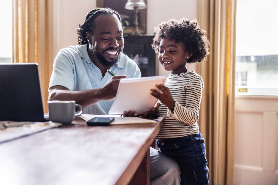 A father and his young daughter doing homework