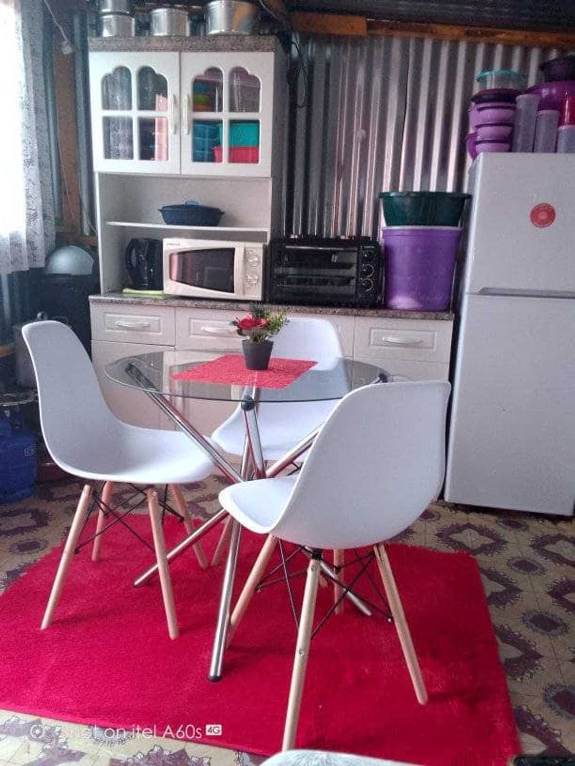 The woman showed off her kitchen furniture.