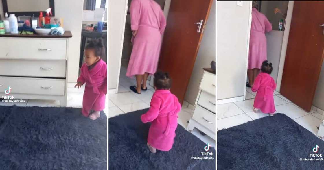 A toddler in matching pink gowns with grandmother A toddler in matching pink gowns with grandmother
