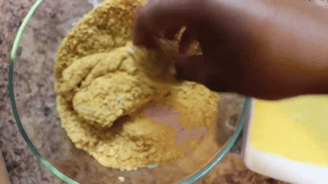 Coating chicken tenders with cornflakes mixture Coating chicken tenders with cornflakes mixture