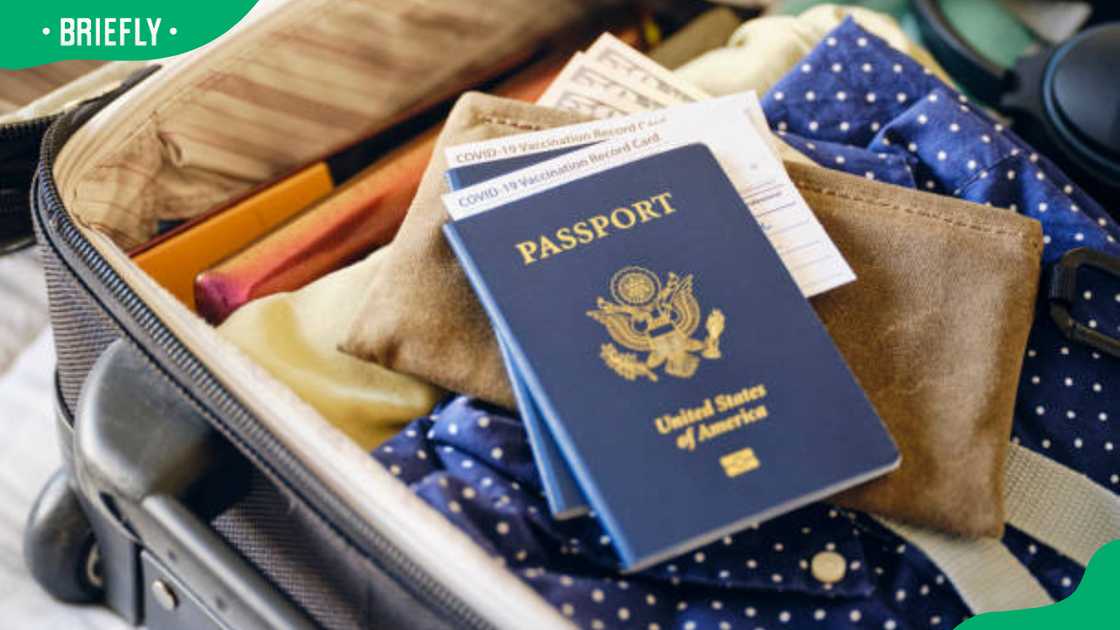 A traveller packing his bags and his travel documents A traveller packing his bags and his travel documents