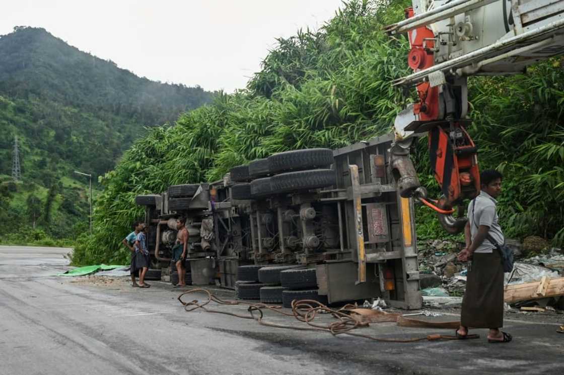 Monsoon-soaked hills periodically shed rocks and earth onto the road, burying parts of the route for days