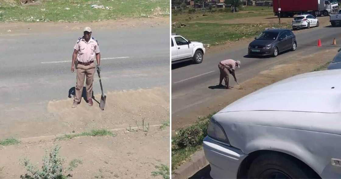 Traffic cop photographed making road safe for motorists after storm Traffic cop photographed making road safe for motorists after storm