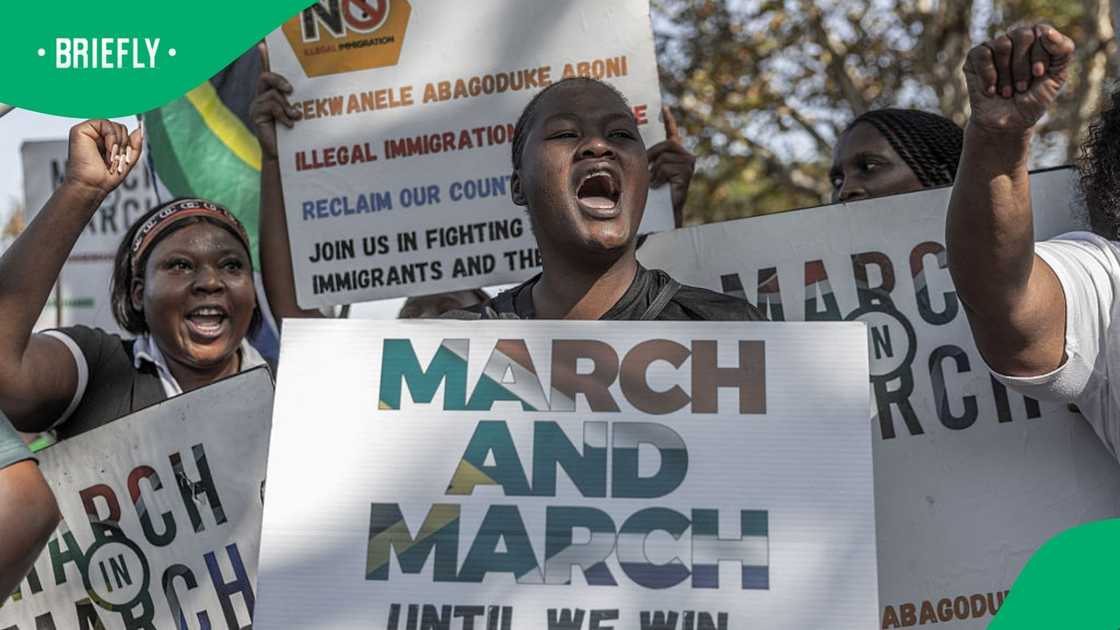 Members of "March and March" hold placards and chant anti-migrant slogans during a protest march in Durban on May 20, 2026 Members of "March and March" hold placards and chant anti-migrant slogans during a protest march in Durban on May 20, 2026