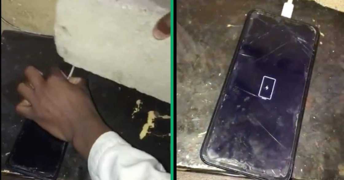 A man charges his phone with a brick to keep it on