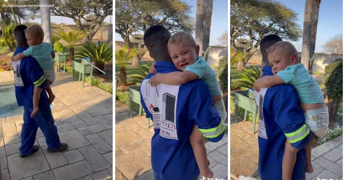 A toddler reacted cutely to a construction worker holding him. A toddler reacted cutely to a construction worker holding him.