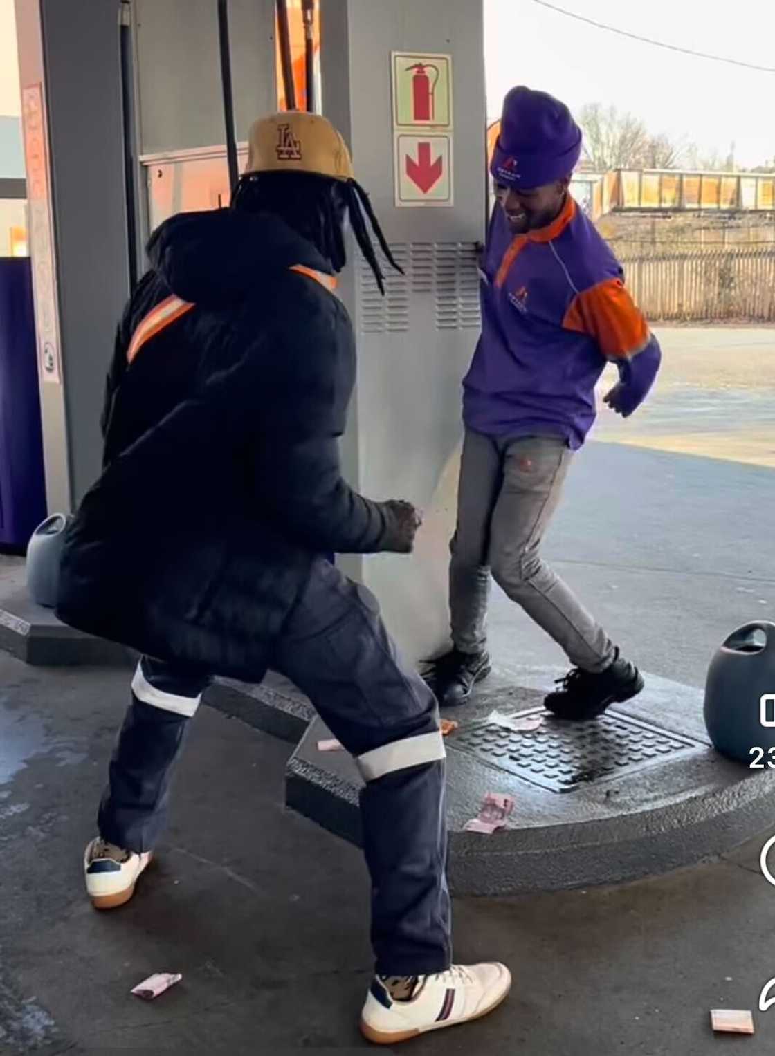 A customer made it rain on a petrol attendant as they danced together.