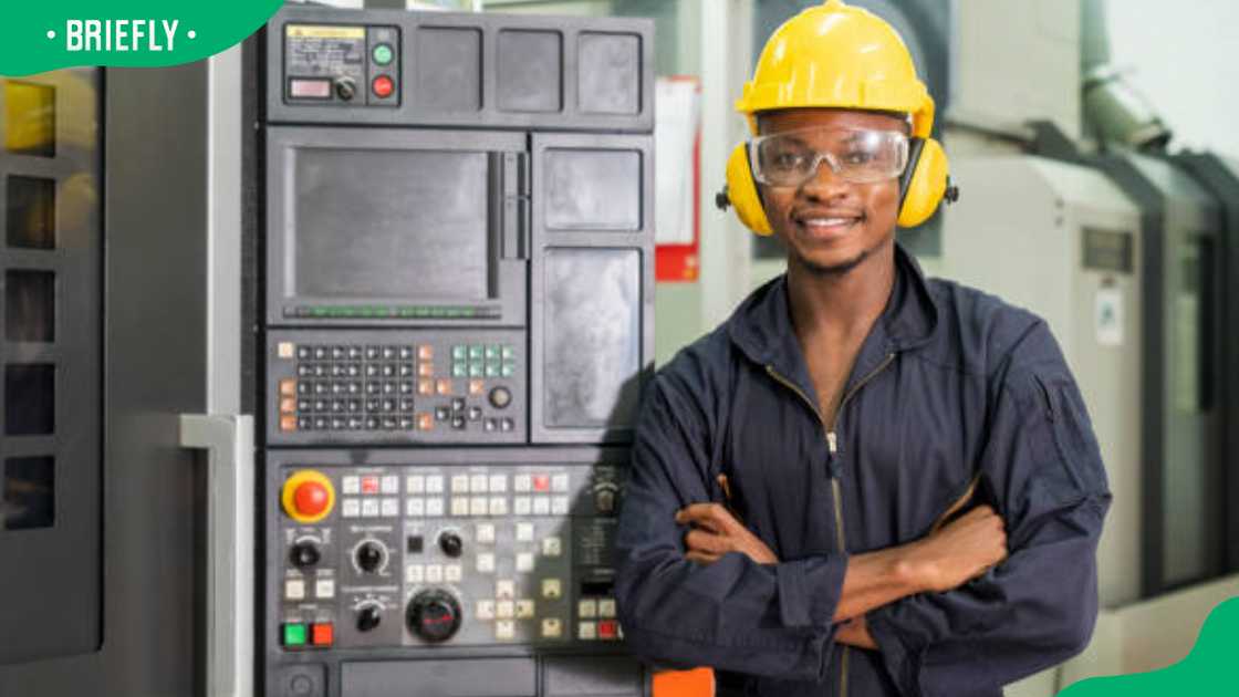 An electrical technician controlling industrial machinery An electrical technician controlling industrial machinery