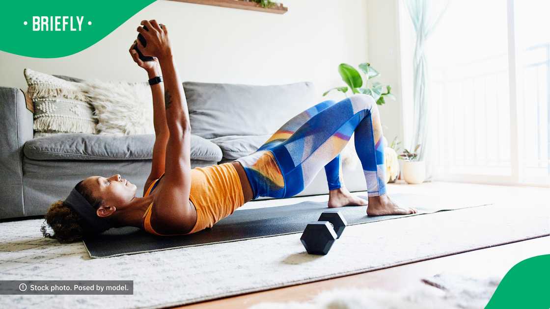 The woman kept her work out routine in check. The woman kept her work out routine in check.