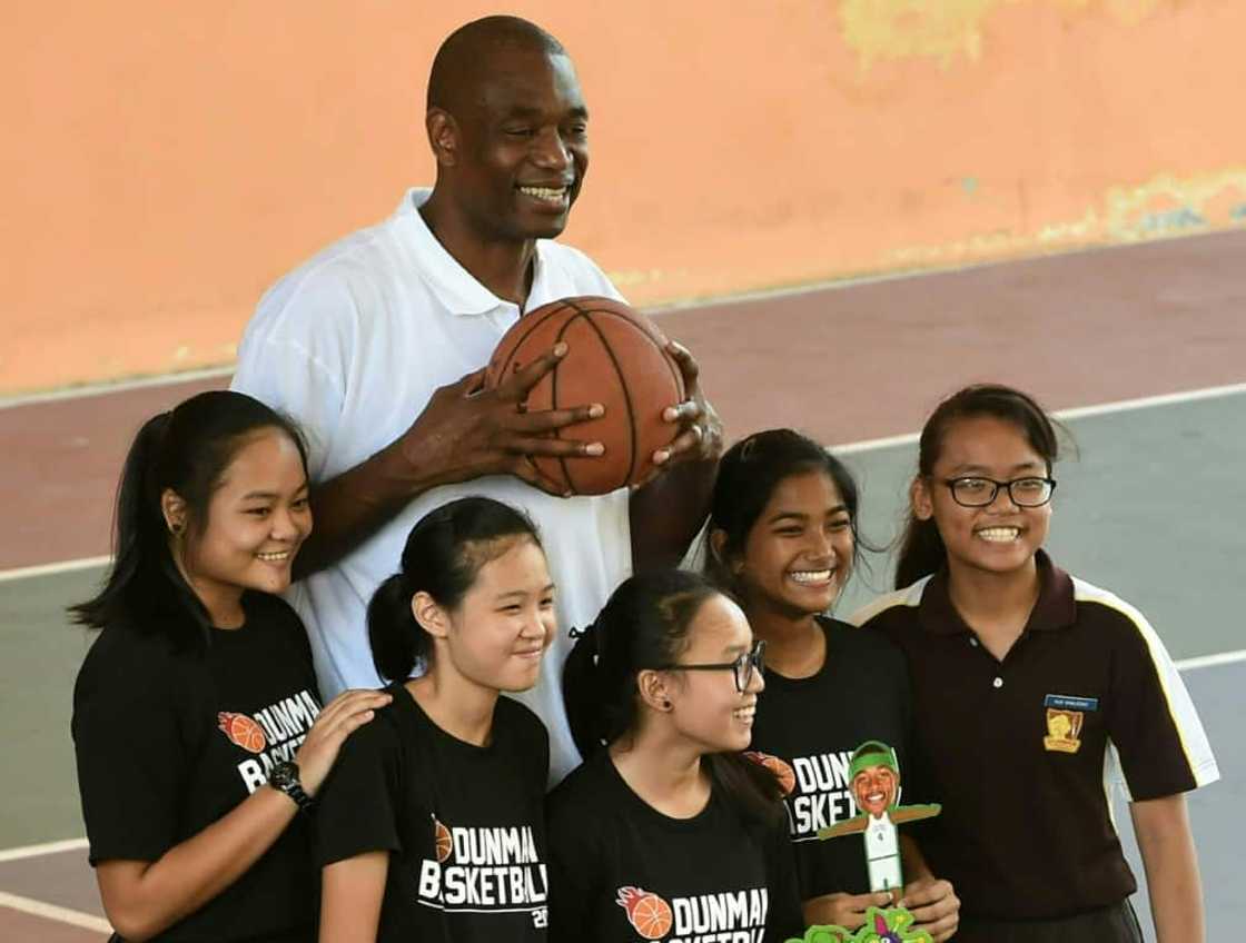Retired NBA great Dikembe Mutombo -- seen here in 2020 with schoolchildren in Singapore -- is undergoing treatment for a brain tumor Retired NBA great Dikembe Mutombo -- seen here in 2020 with schoolchildren in Singapore -- is undergoing treatment for a brain tumor