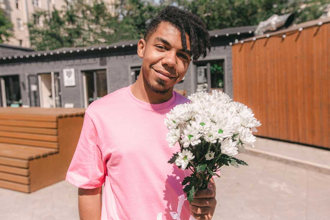 A man posing with flowers