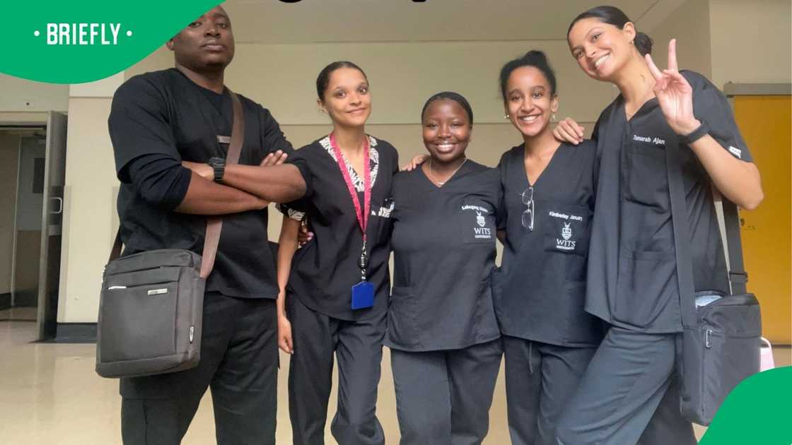 A group of young doctors posed in their medical uniforms