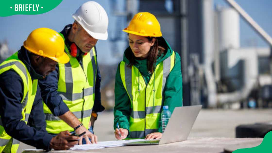 Engineers discussing at industrial facility Engineers discussing at industrial facility
