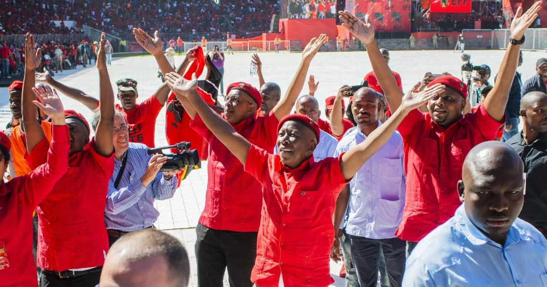 Julius Malema, leader of the Economic Freedom Fighters (EFF), center, waves to the crowd during an Economic Freedom Fighters party campaign rally in Soweto, Johannesburg Julius Malema, leader of the Economic Freedom Fighters (EFF), center, waves to the crowd during an Economic Freedom Fighters party campaign rally in Soweto, Johannesburg