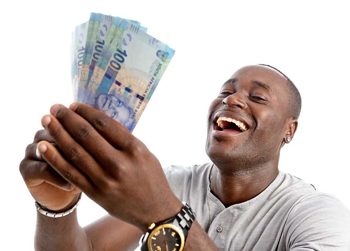 A stock photo of a man counting South African money A stock photo of a man counting South African money