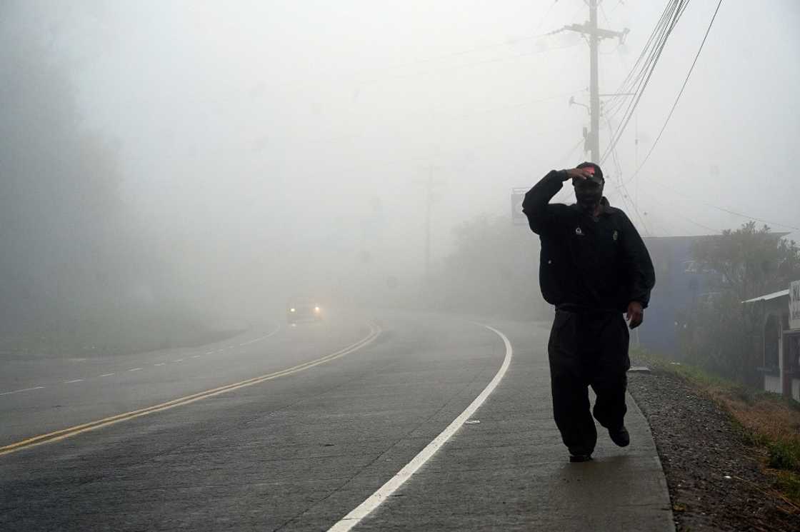 A man walks along a road in the town of Santa Ana, in Honduras's Francisco Morazan department, on October 9, 2022, shortly before the arrival of Hurricane Julia A man walks along a road in the town of Santa Ana, in Honduras's Francisco Morazan department, on October 9, 2022, shortly before the arrival of Hurricane Julia