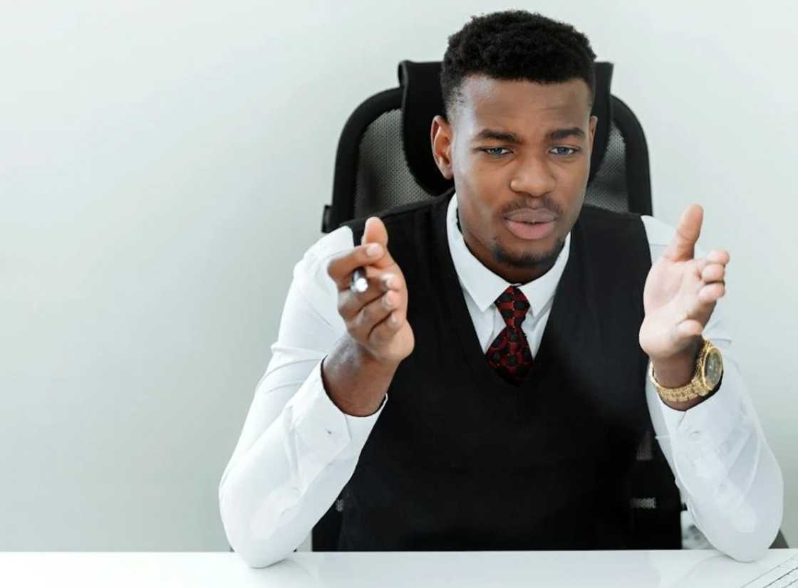 A serious young man in the middle of a conversation in the office