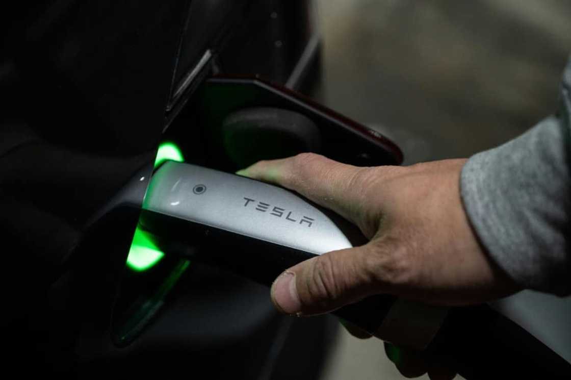 Atsushi Ikeda, founder of a club for Tesla owners in Japan, charges his Tesla Model S at a charging station in Tokyo Atsushi Ikeda, founder of a club for Tesla owners in Japan, charges his Tesla Model S at a charging station in Tokyo