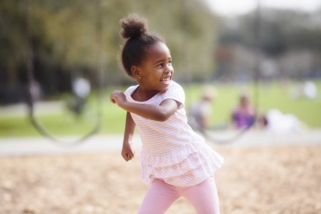 A young girl playing in the park