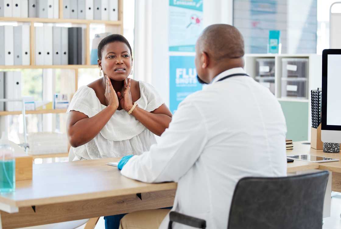 A woman consults a doctor about throat strain from overuse. A woman consults a doctor about throat strain from overuse.