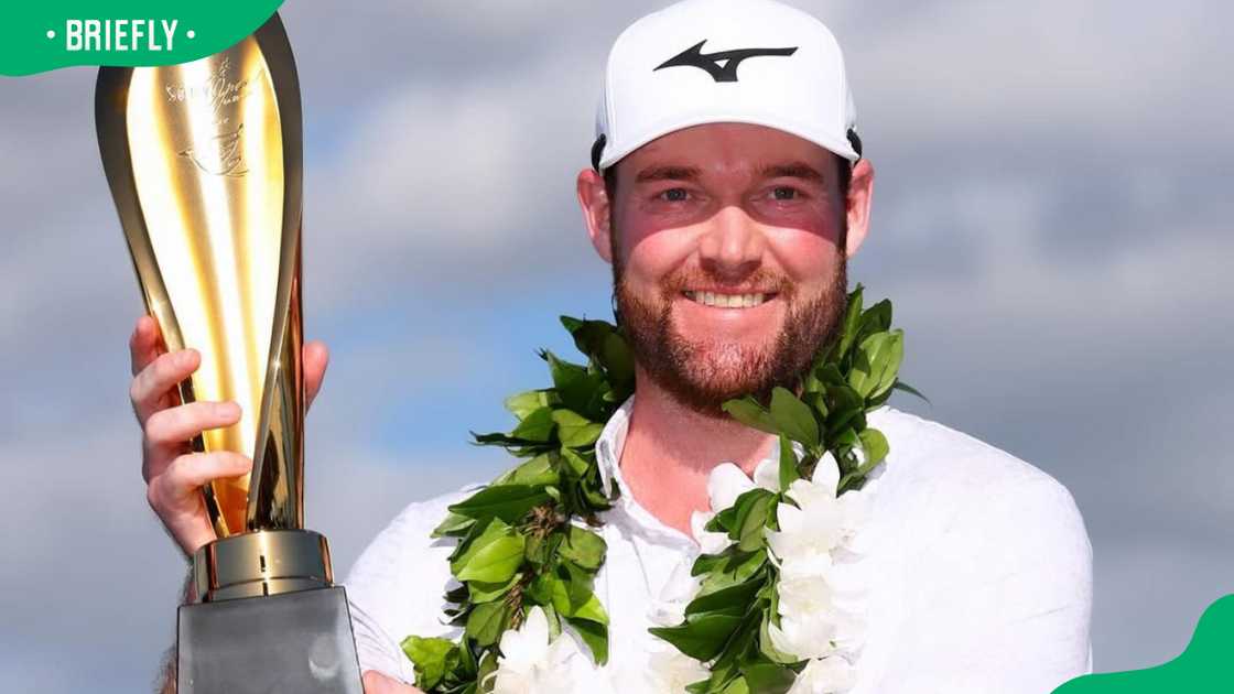 Grayson Murray posing with the championship trophy