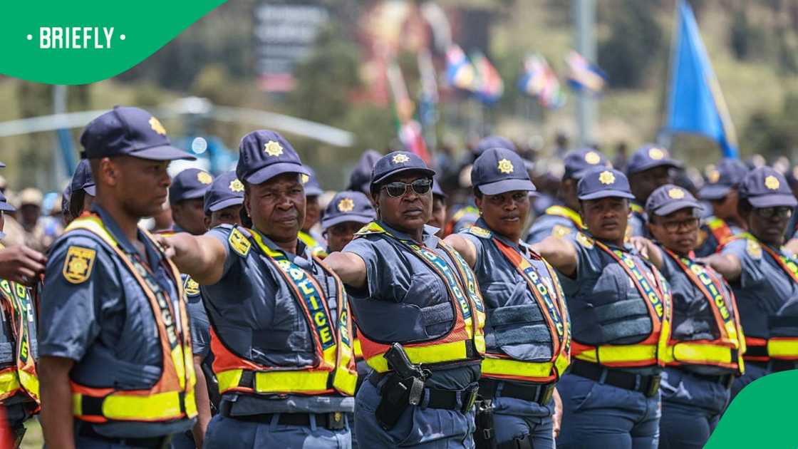 Members of the South African Police Service react during the Integrated Law Enforcement parade near the Nasrec Expo Centre in Johannesburg, on November 19, 2025