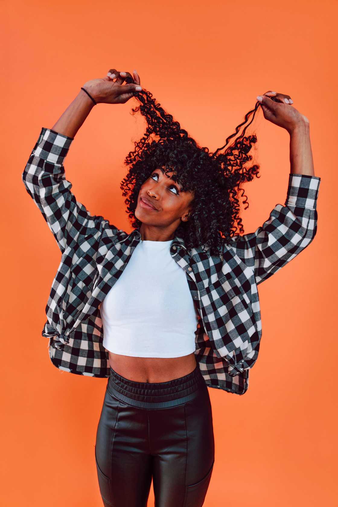 A woman pulling her hair.