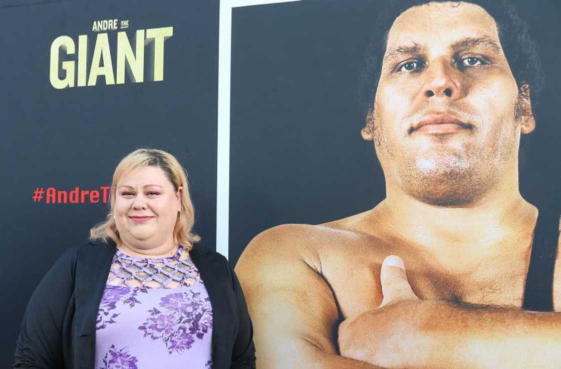 André the Giant's daughter Robin infront of his poster