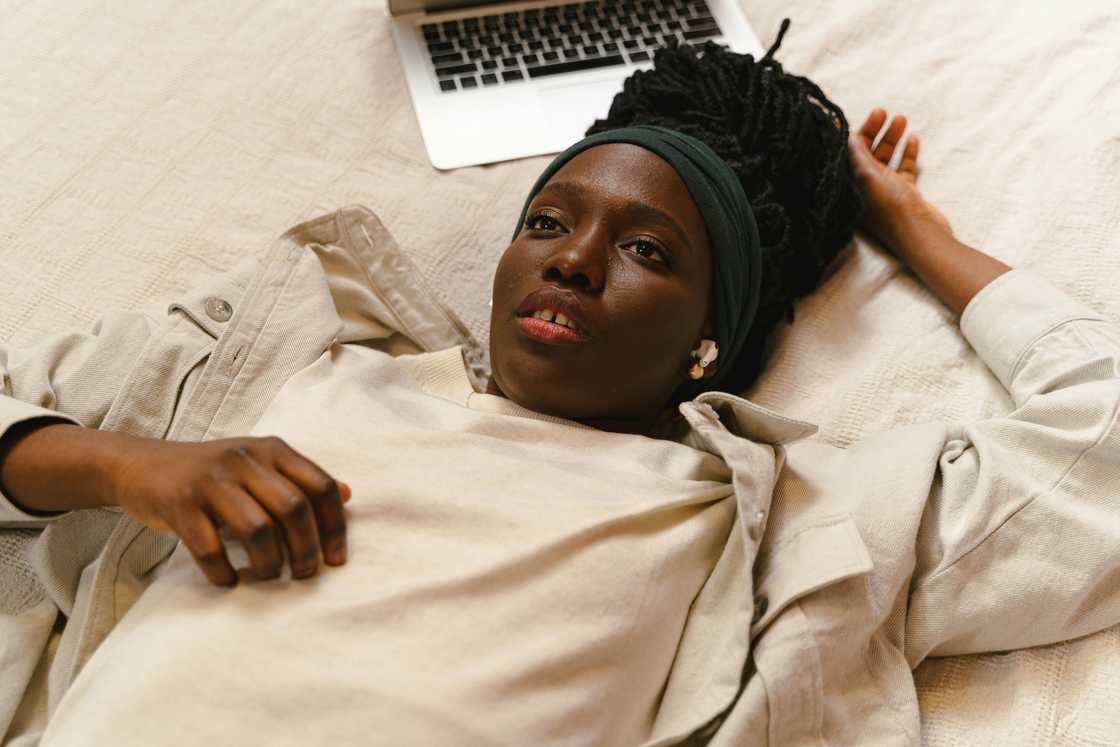 A woman resting on a bed