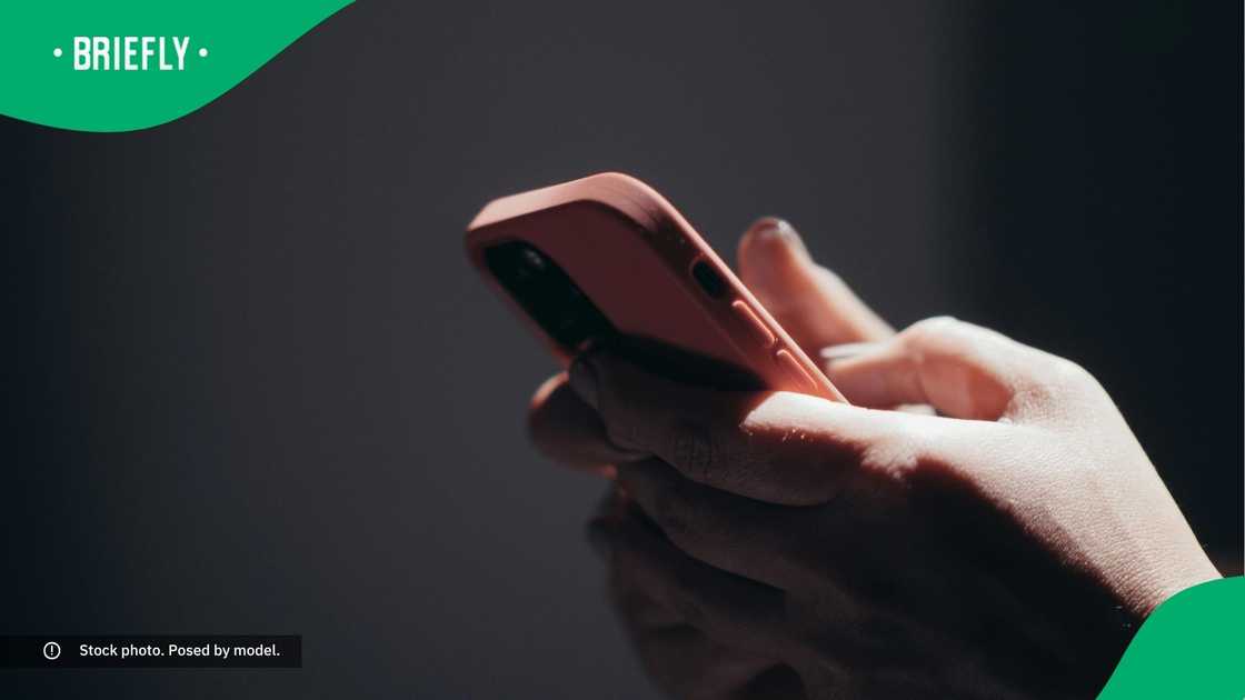 A woman typing on her phone. A woman typing on her phone.