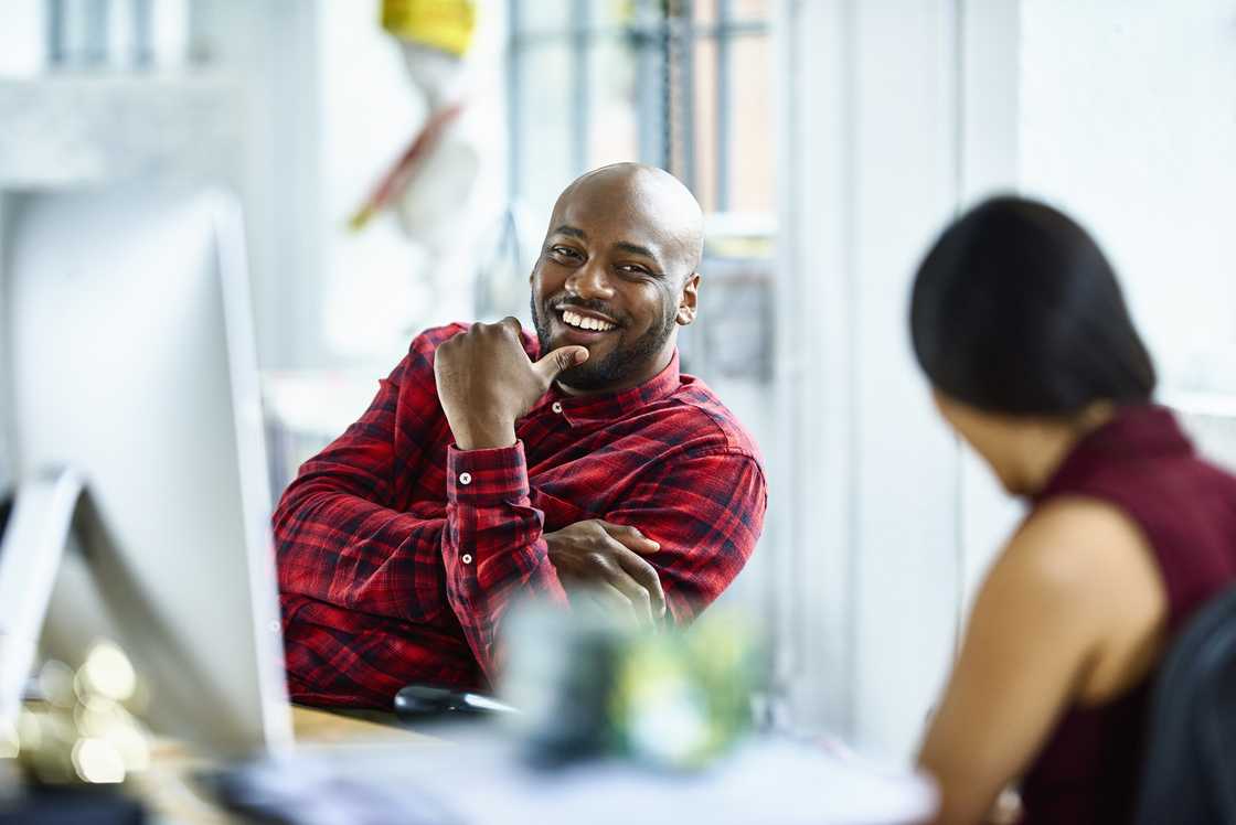 A man and woman talking in an office
