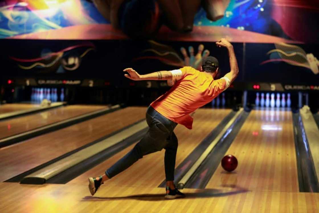 An Iraqi delivers a ball at a bowling alley in Baghdad