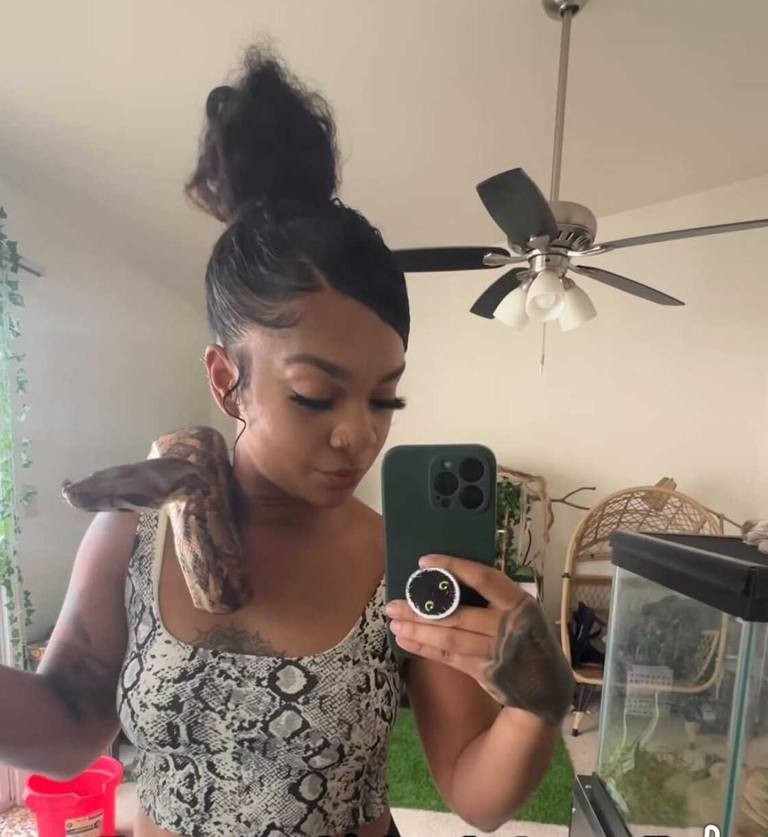 A woman displayed her calmness while handling her massive pet snake.