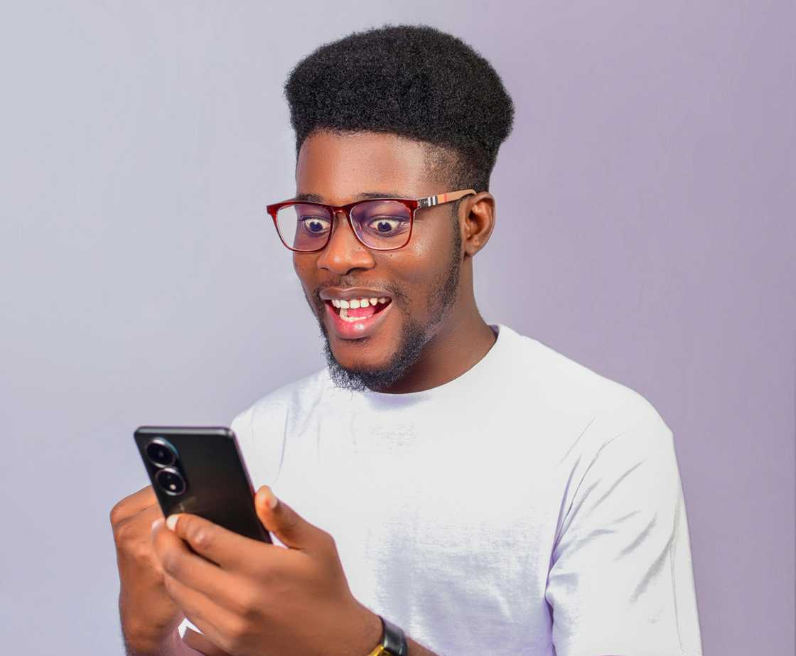 happy student seeing a notification in his phone