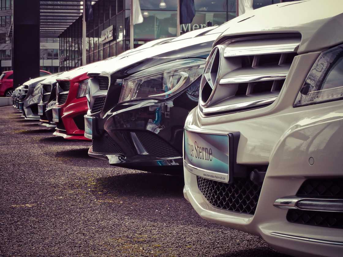 An image of luxury cars lined up in the parking lot. An image of luxury cars lined up in the parking lot.