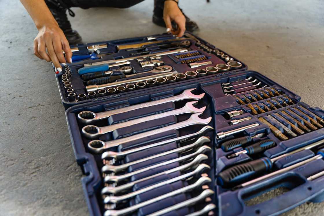 A person arranges tools inside an open mechanic’s toolkit. A person arranges tools inside an open mechanic’s toolkit.