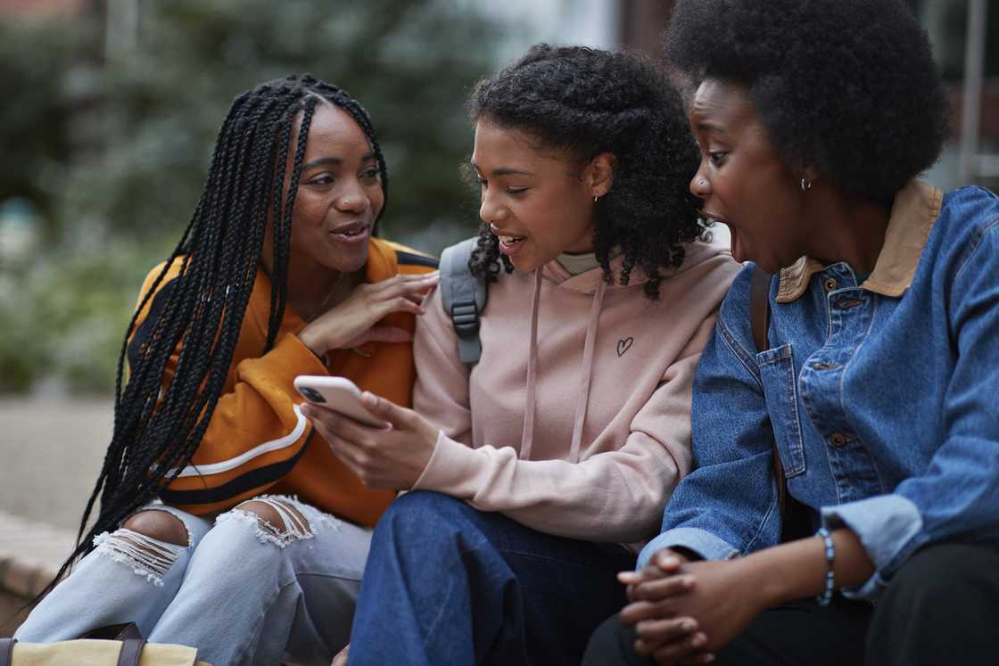 A group of girls gossiping. A group of girls gossiping.