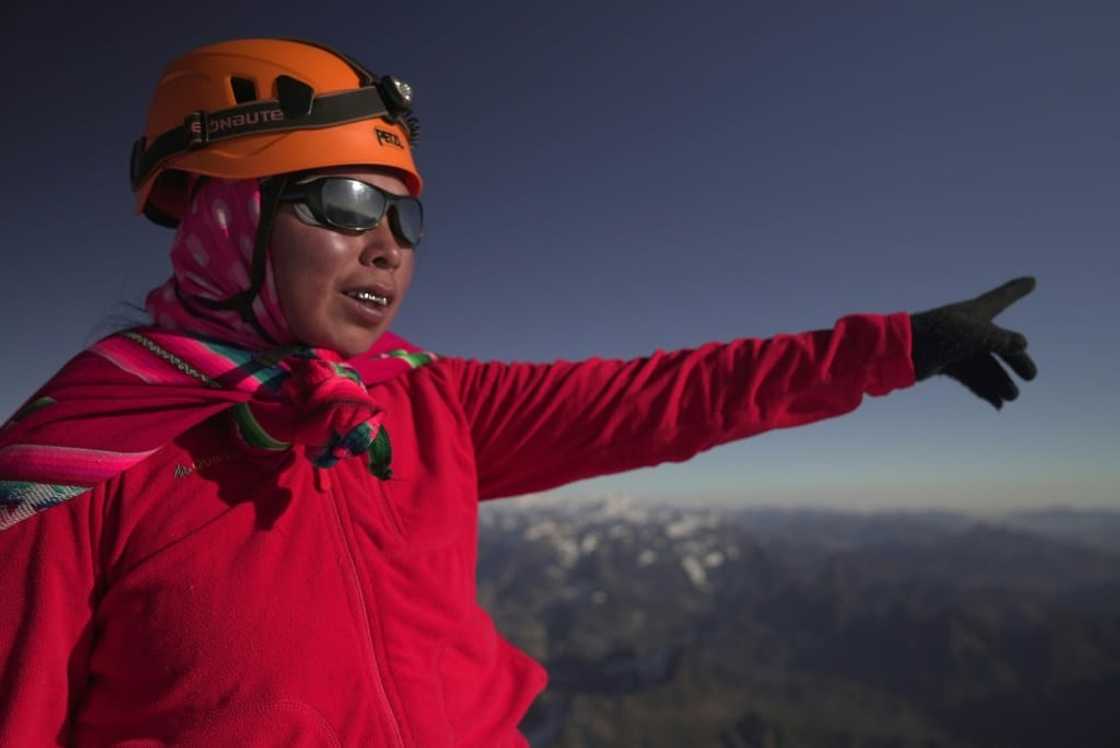 Janet Mamani, an Aymara indigenous woman member of the Climbing Cholitas of Bolivia Warmis, looks satisfied with her night's trek after arriving at the summit of the Huayna Potosi mountain Janet Mamani, an Aymara indigenous woman member of the Climbing Cholitas of Bolivia Warmis, looks satisfied with her night's trek after arriving at the summit of the Huayna Potosi mountain