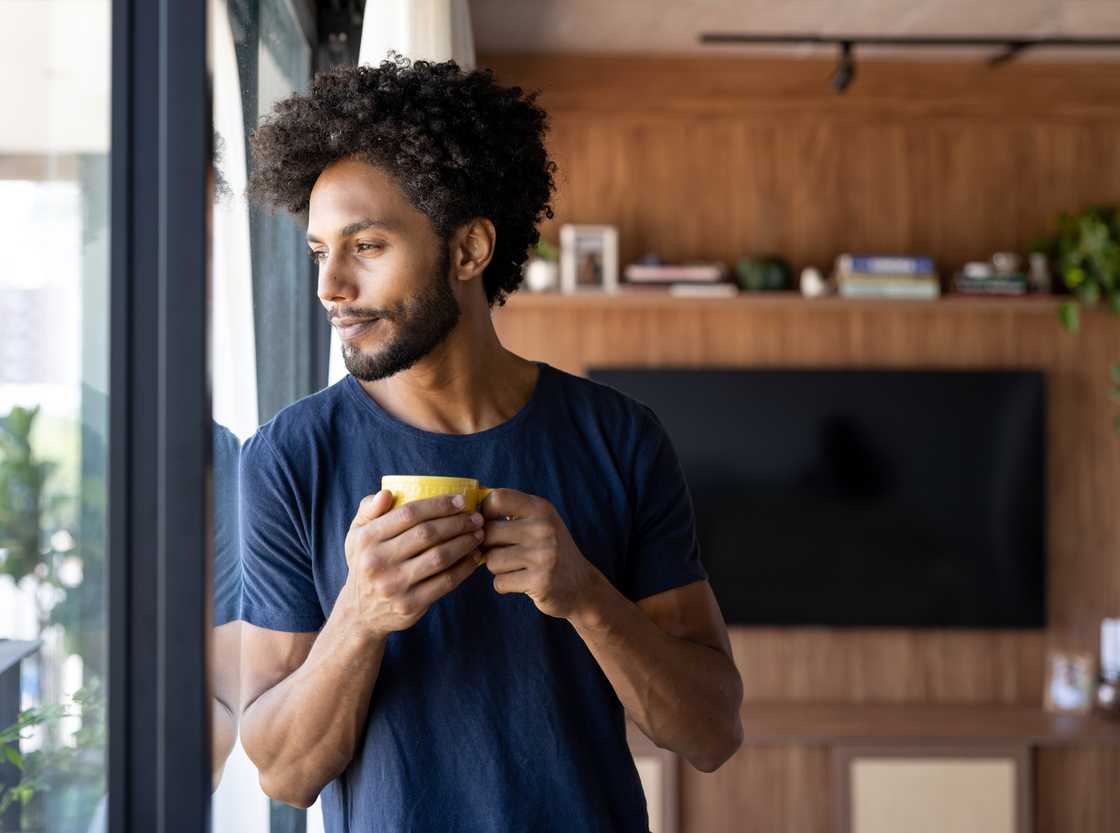 A happy man drinking a cup of coffee