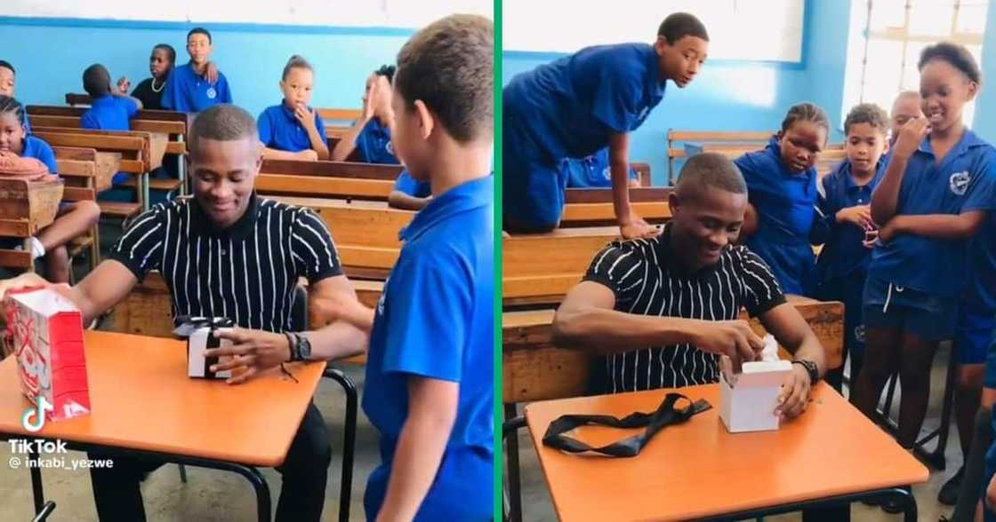 A teacher unwrapped his gift in front of learners A teacher unwrapped his gift in front of learners