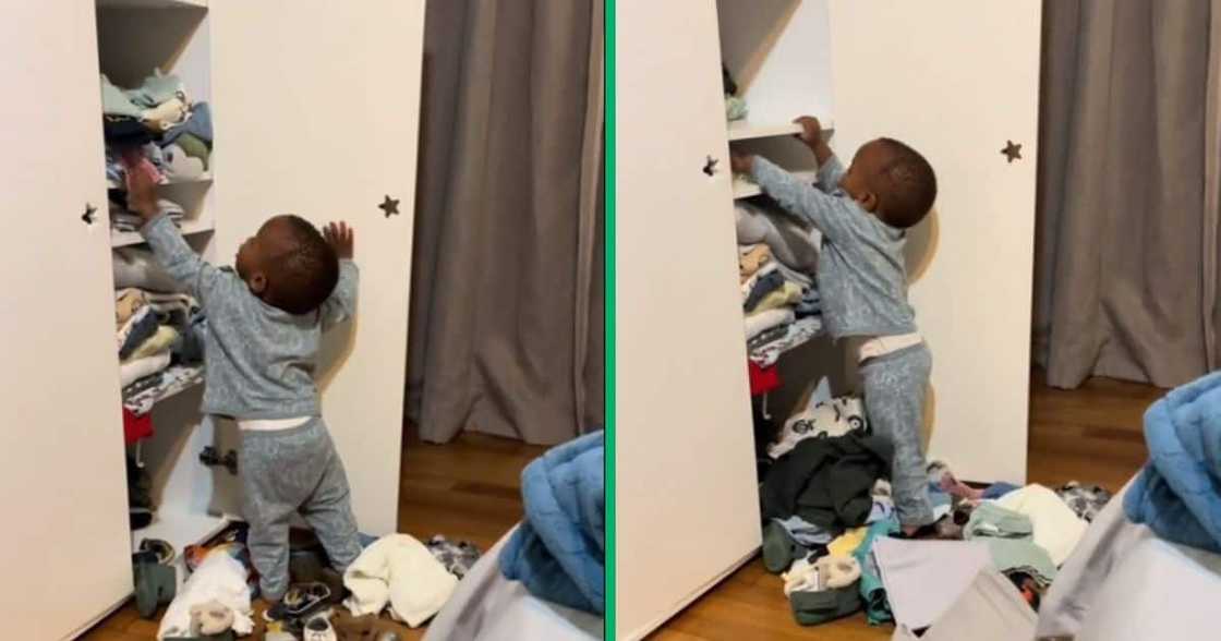 Child unpacking clothes from the wardrobe Child unpacking clothes from the wardrobe