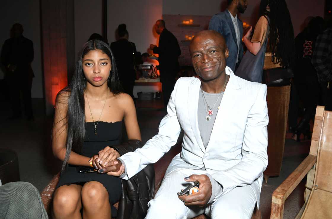 Lou Samuel and her father Seal holding hands while seated Lou Samuel and her father Seal holding hands while seated