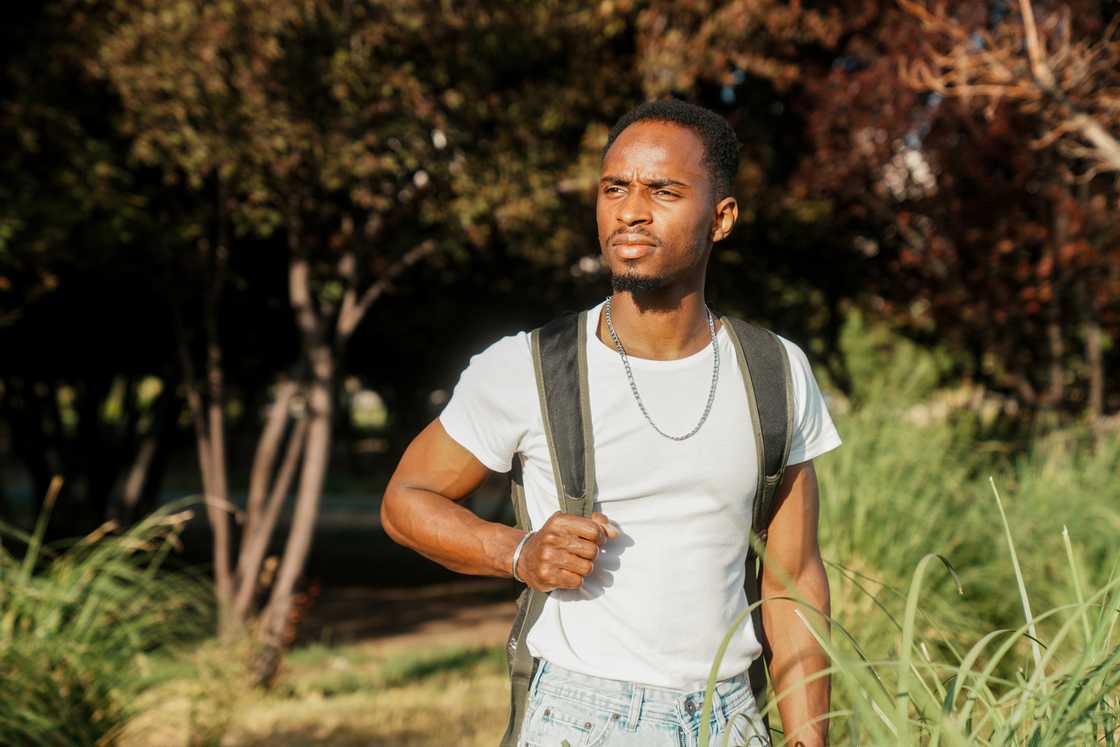 A student walking with a bag on his back