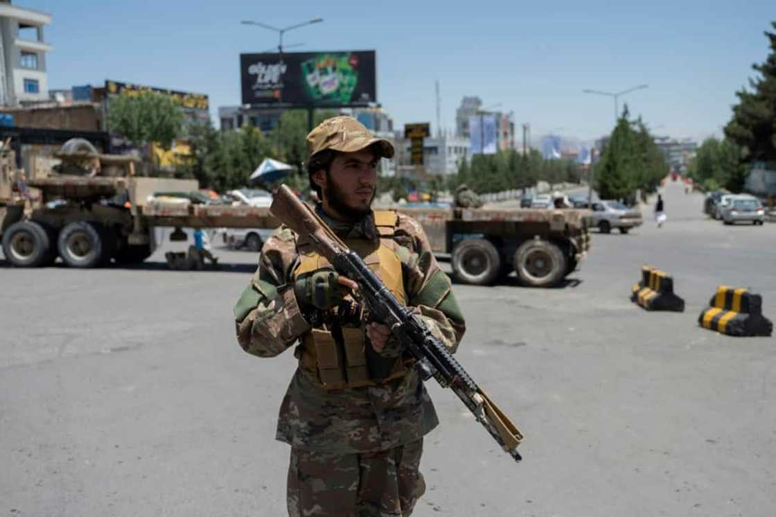 A Taliban fighter stands guard near where thousands of clerics met to discuss Afghanistan's new government A Taliban fighter stands guard near where thousands of clerics met to discuss Afghanistan's new government