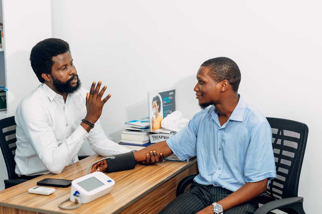 Doctor checks a man’s blood pressure during a clinic visit. Doctor checks a man’s blood pressure during a clinic visit.