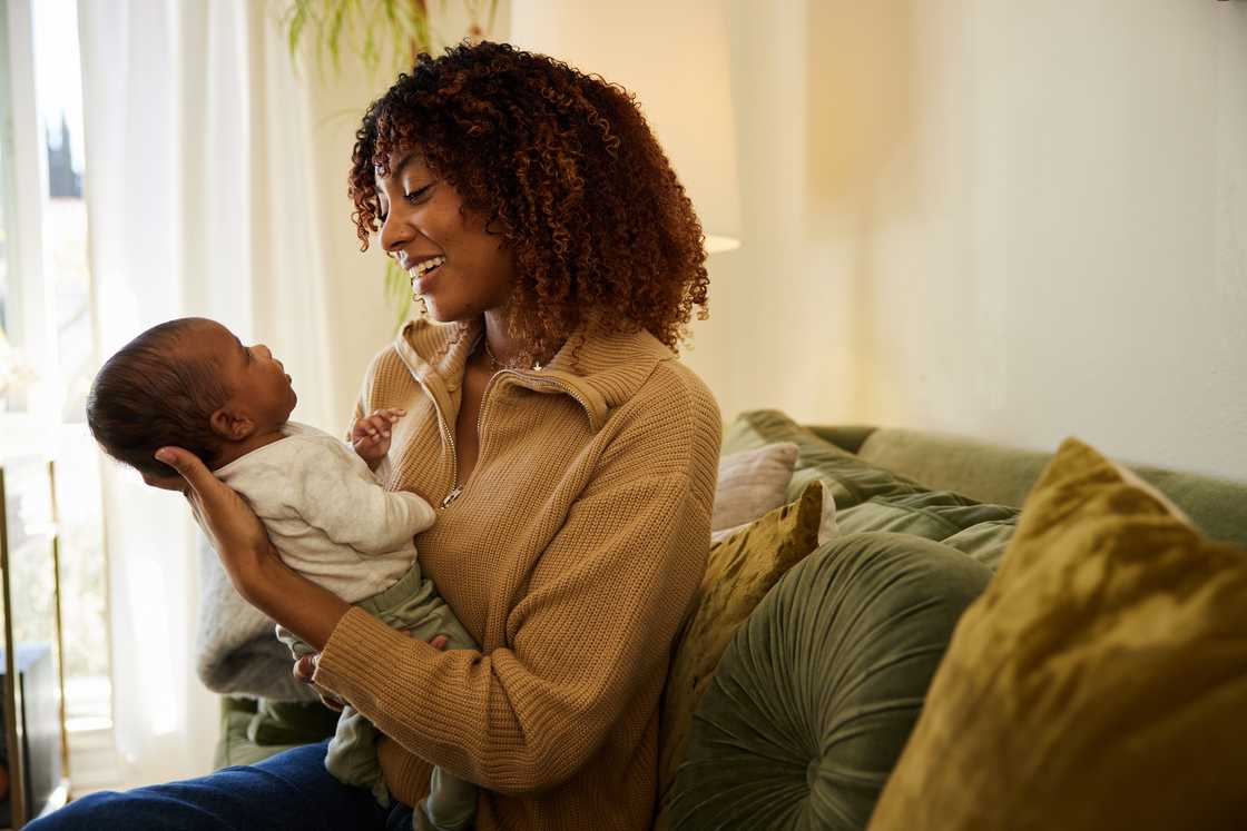 A lady holds a young baby