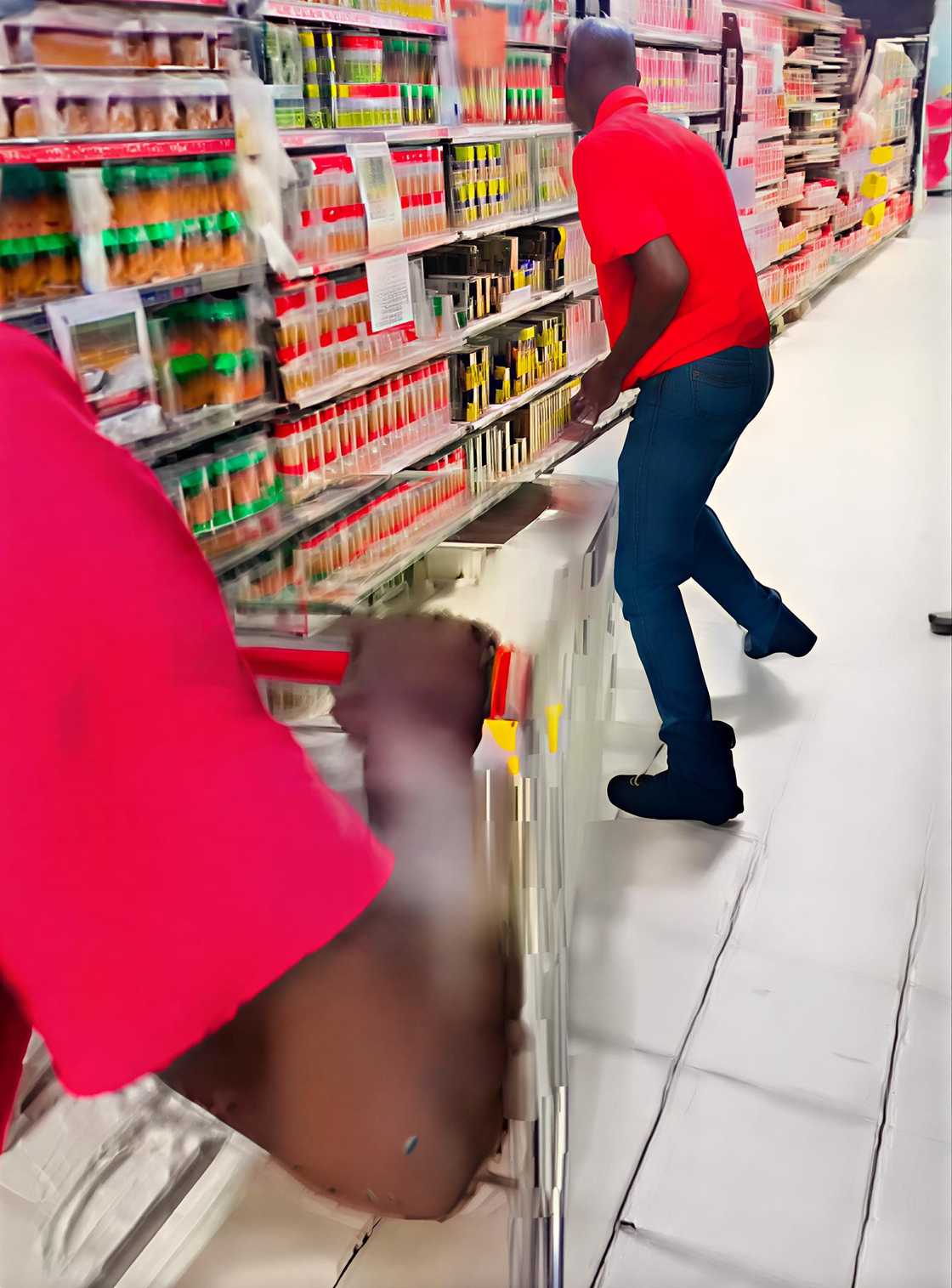 A man in South Africa is swiftly loading meat into a trolley during the dash.
