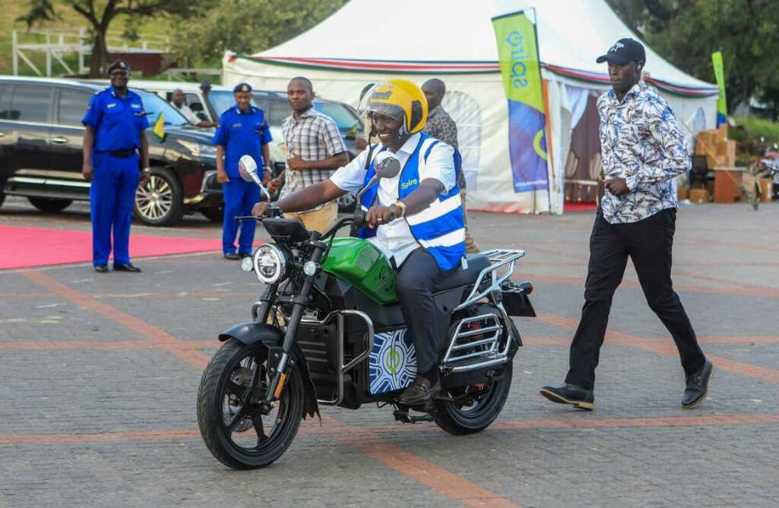 Kenyan President William Ruto takes a ride on one of the new e-bikes