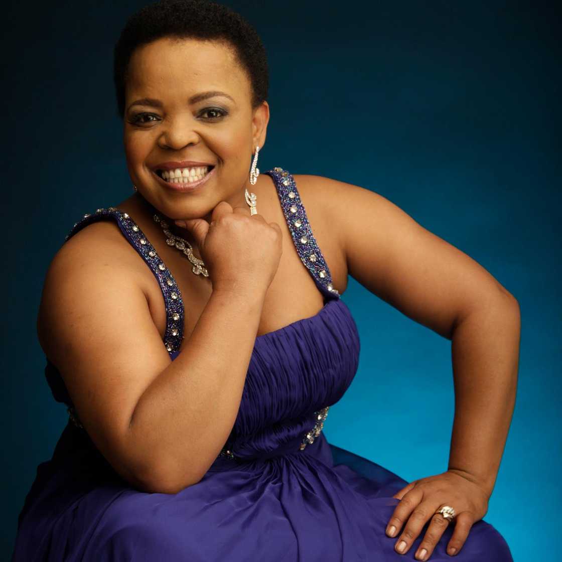 Rebecca Malope in a purple dress