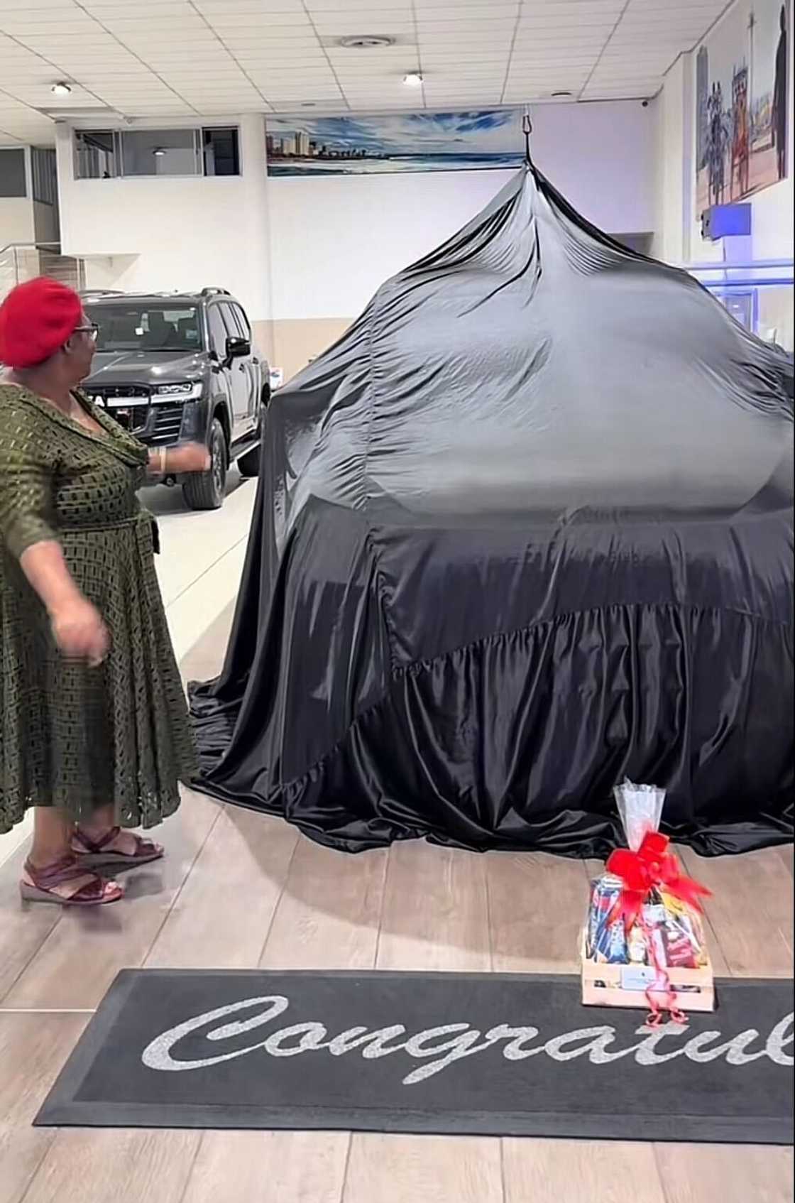 A TikTok video shows a gogo receiving a beautiful, expensive car. A TikTok video shows a gogo receiving a beautiful, expensive car.